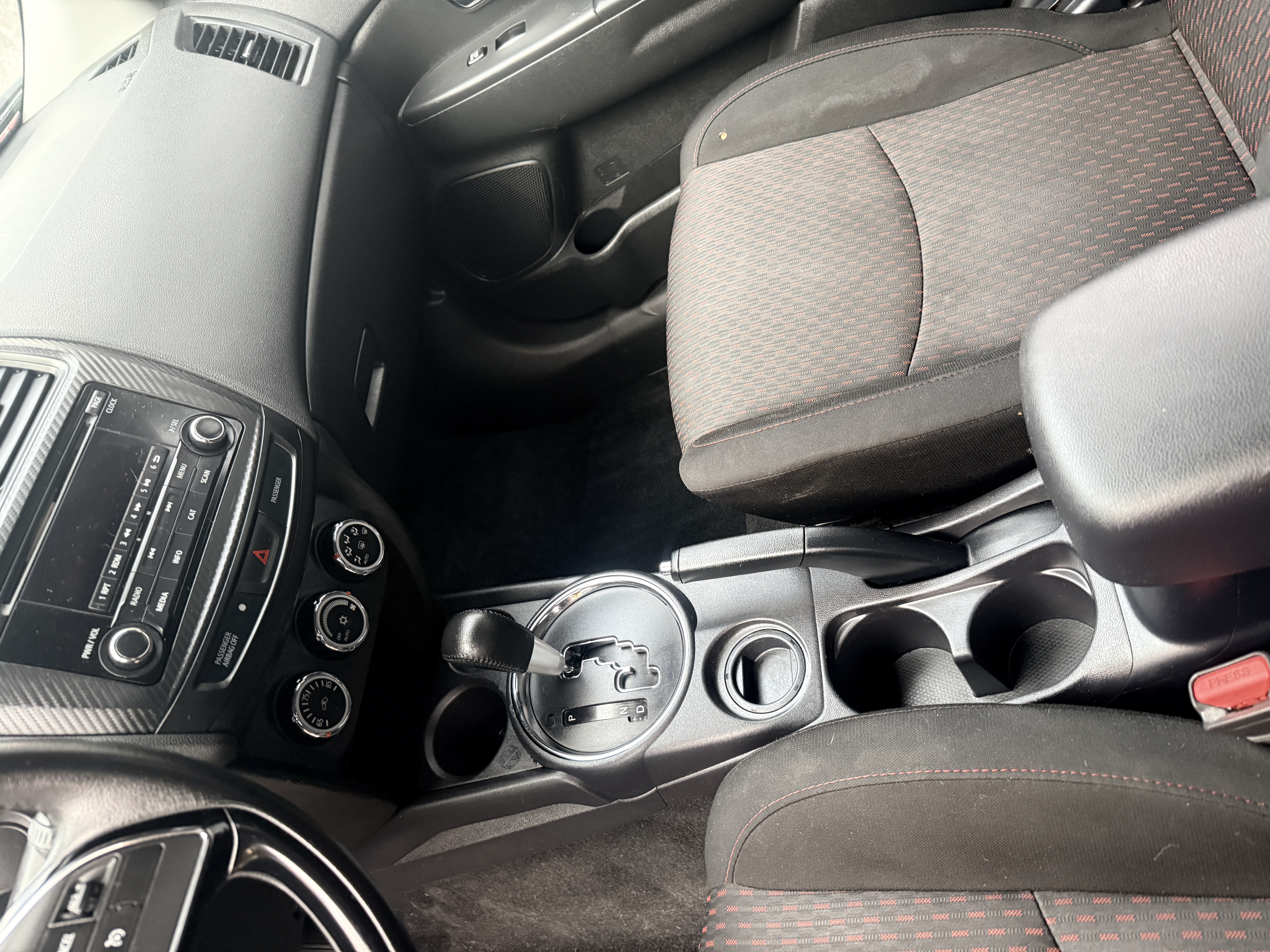 Same Mitsubishi center console after detail, cupholders and vents fully clean