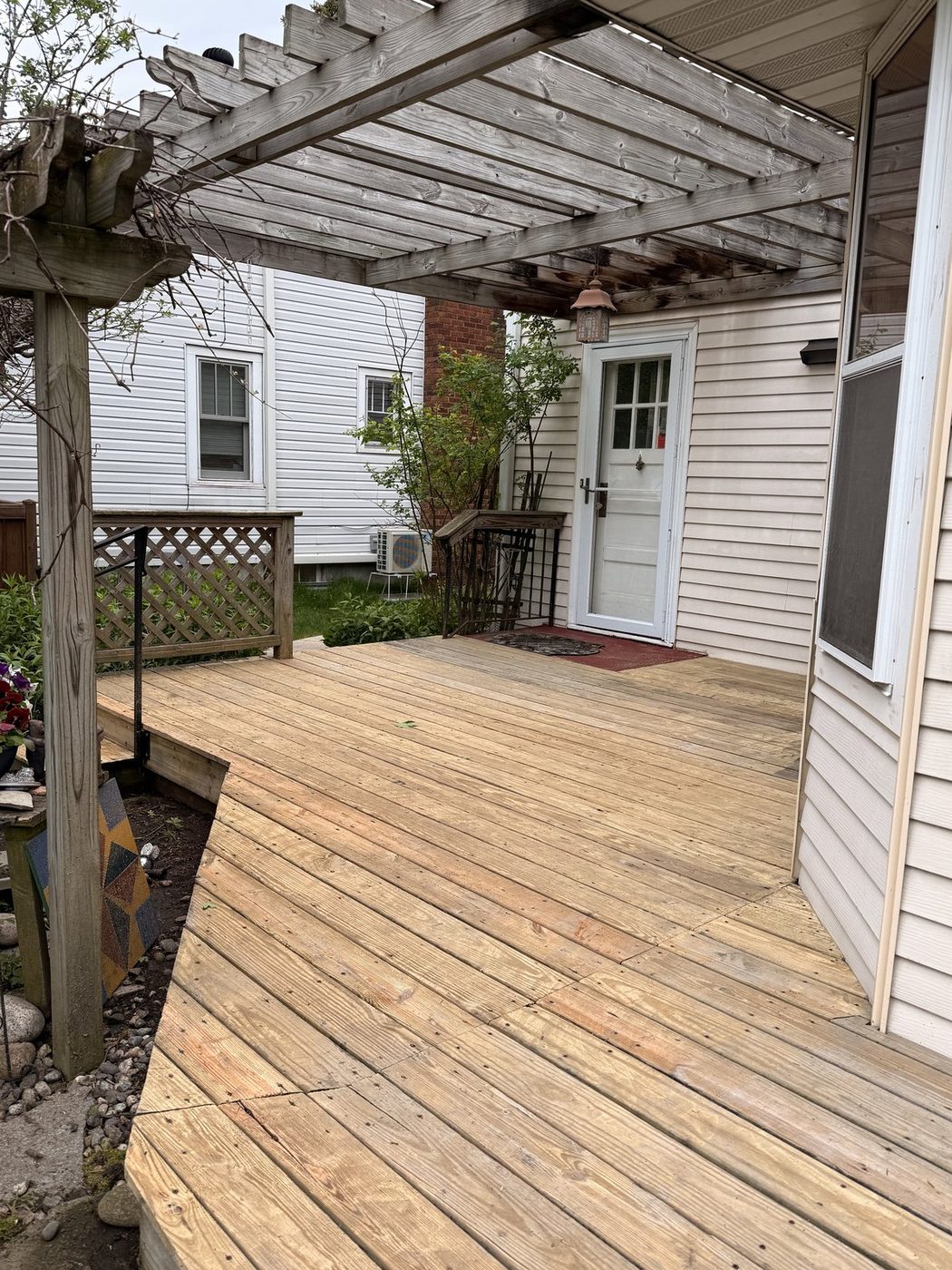 Same deck after pressure washing, bright clean golden wood
