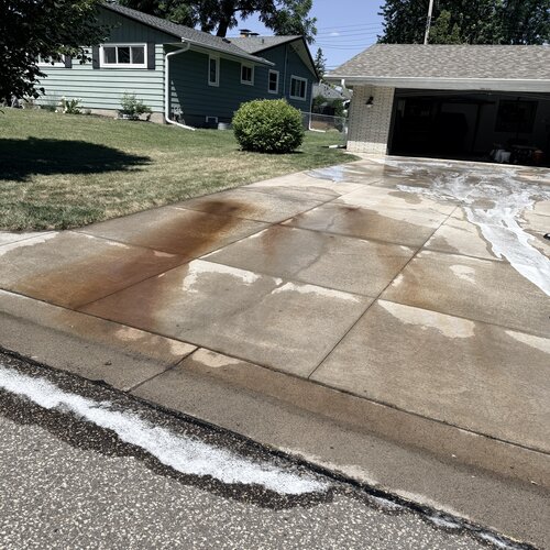 Close-up of rust staining bleeding across the driveway seams
