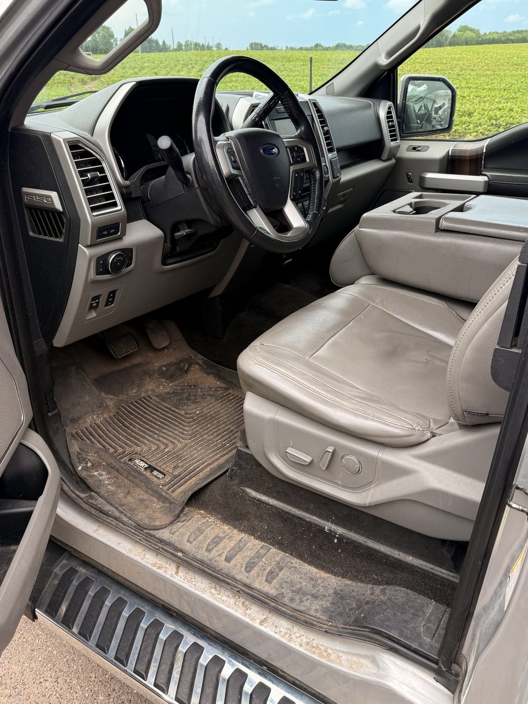 Ford F-150 work truck interior before detail, muddy floor mats